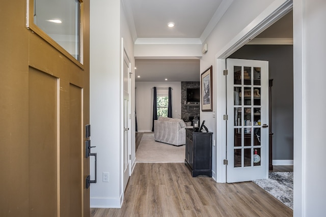 hall featuring wood-type flooring and ornamental molding