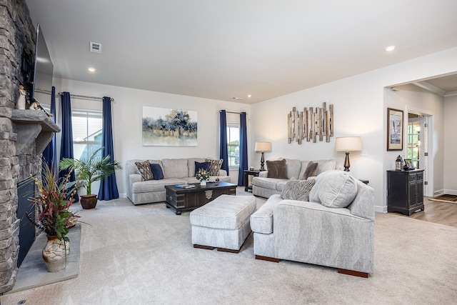 living room featuring a fireplace and light carpet