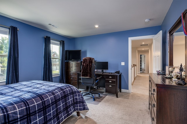 bedroom featuring light carpet