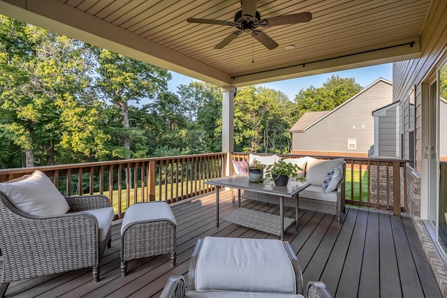 deck with an outdoor living space and ceiling fan