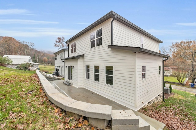 view of side of home with central AC and a patio area