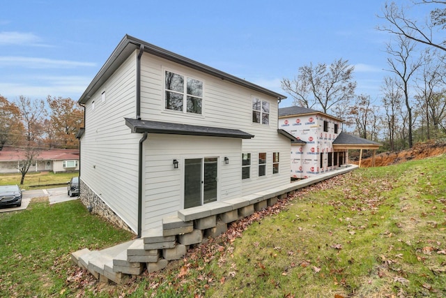 rear view of house with a yard