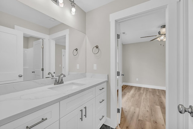 bathroom with vanity, hardwood / wood-style flooring, and ceiling fan