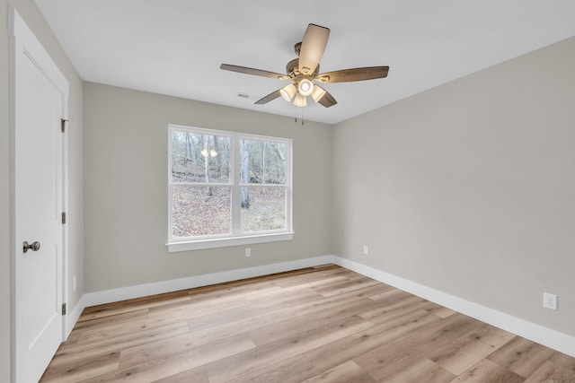 spare room with ceiling fan and light wood-type flooring