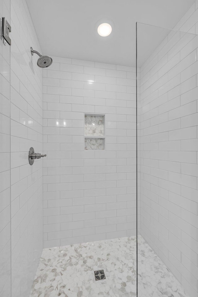 bathroom with tiled shower