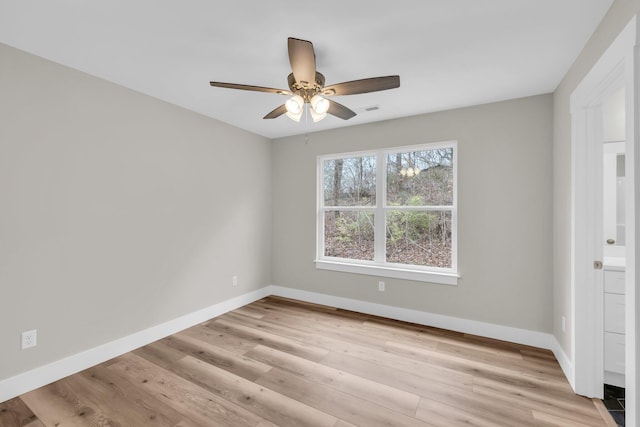 spare room featuring ceiling fan and light hardwood / wood-style flooring