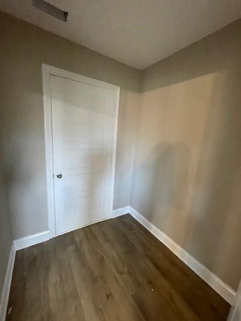 unfurnished room featuring dark hardwood / wood-style flooring