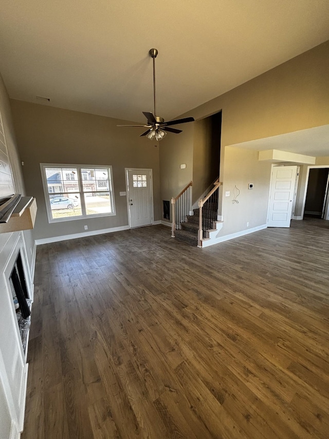 unfurnished living room featuring ceiling fan, dark hardwood / wood-style floors, and a wealth of natural light