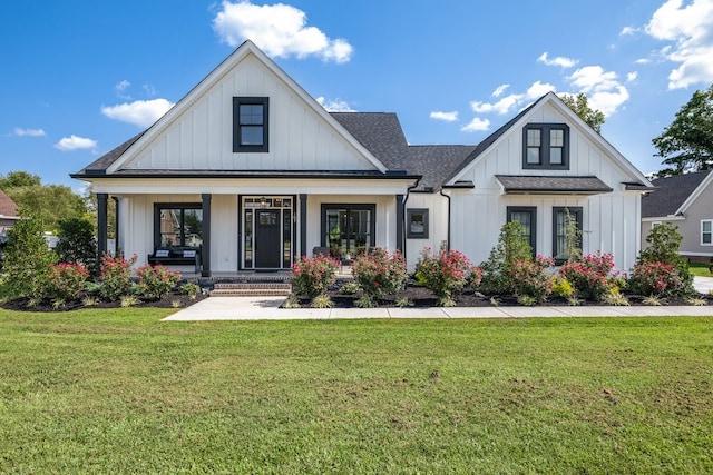 modern inspired farmhouse featuring a front lawn and a porch