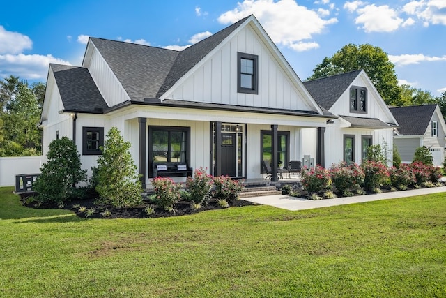 modern farmhouse featuring a front lawn and covered porch