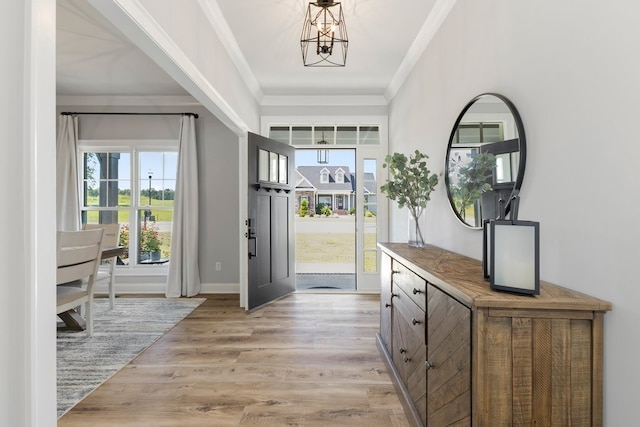 foyer entrance featuring light hardwood / wood-style flooring and crown molding