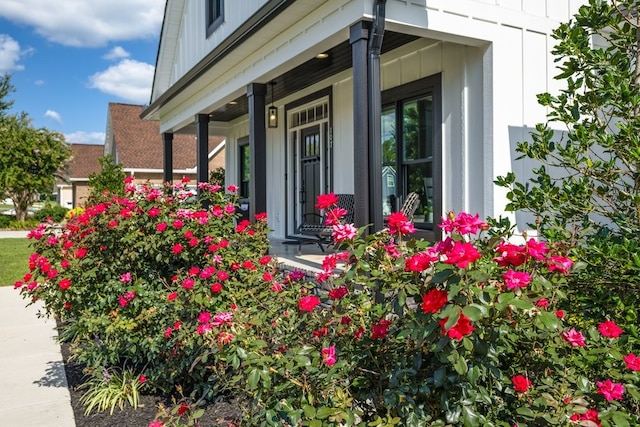 view of exterior entry featuring covered porch