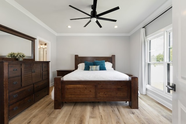 bedroom featuring light wood-type flooring, ornamental molding, and ceiling fan