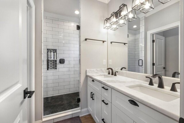 bathroom with dual bowl vanity and walk in shower