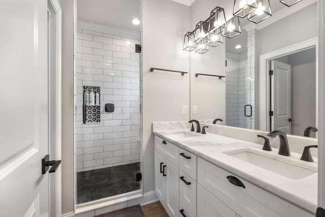 bathroom featuring walk in shower and vanity