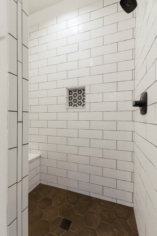 bathroom with a tile shower