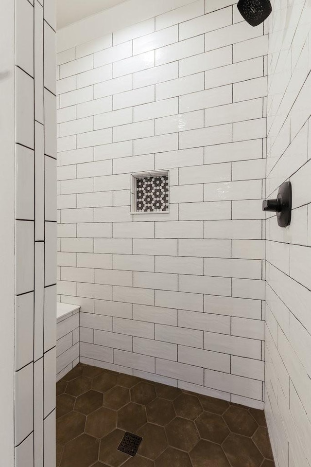 bathroom with a tile shower