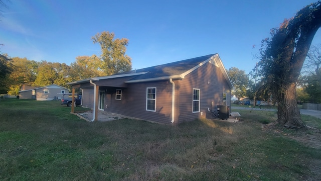 view of property exterior featuring cooling unit and a lawn