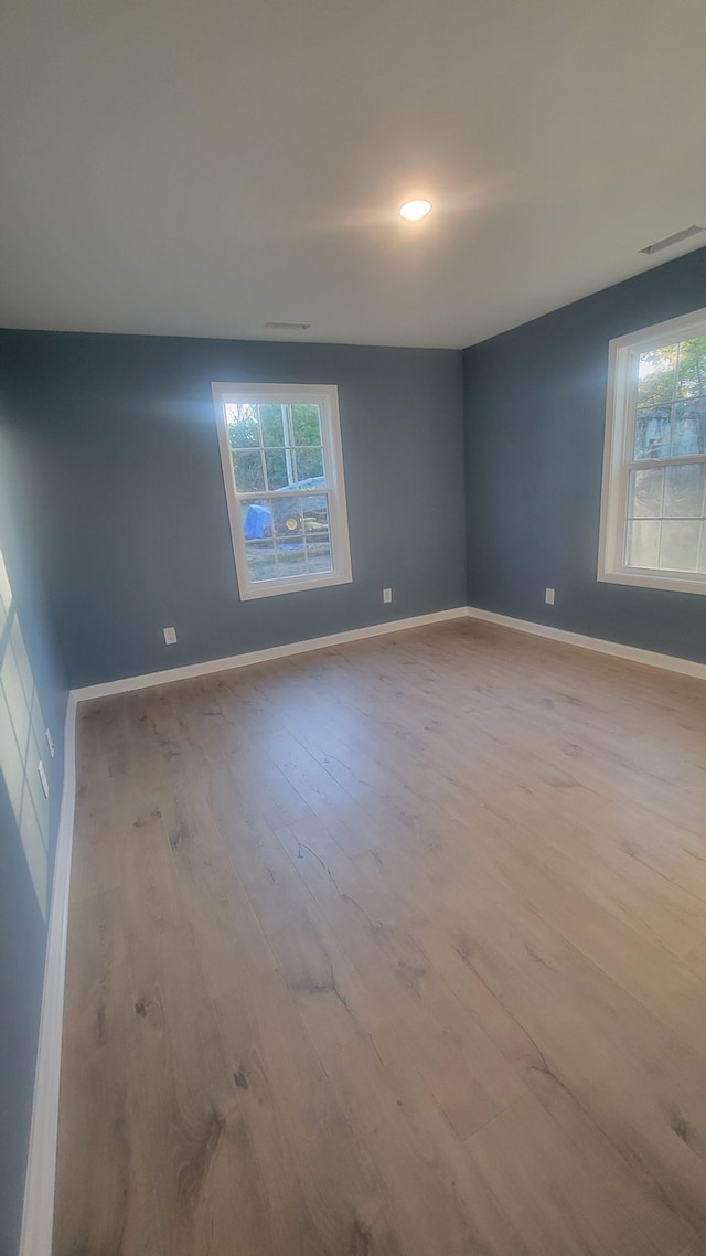 unfurnished room with light wood-type flooring