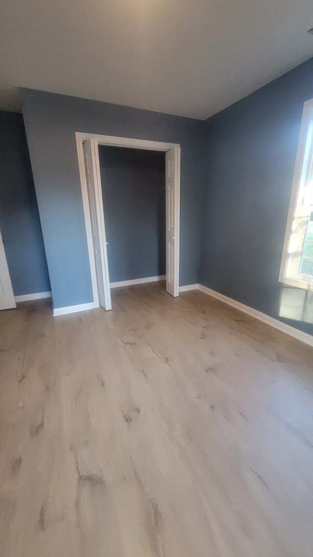 unfurnished room with light wood-type flooring