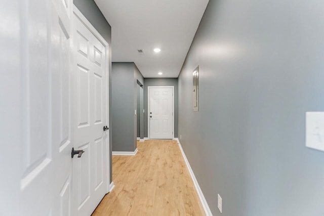 corridor with light hardwood / wood-style flooring