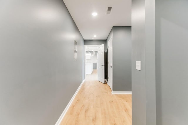 corridor with light wood-type flooring