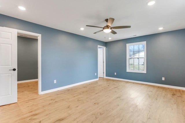 spare room with ceiling fan and light hardwood / wood-style flooring