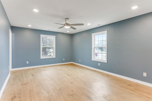 unfurnished room with ceiling fan and light hardwood / wood-style floors