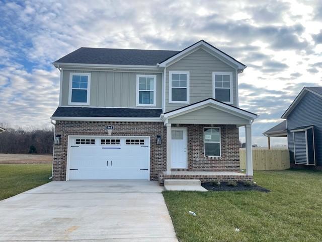 view of front of property featuring a front lawn and a garage