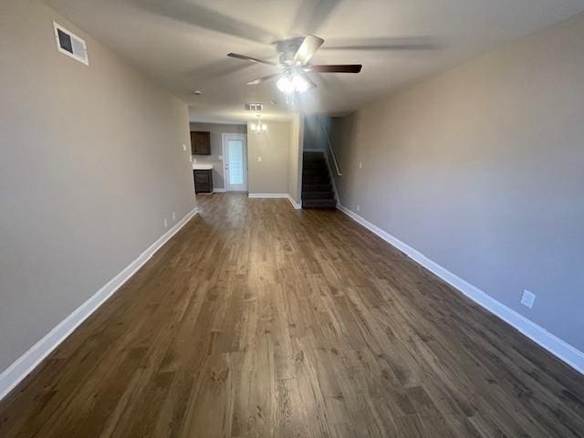 unfurnished living room featuring dark hardwood / wood-style floors and ceiling fan