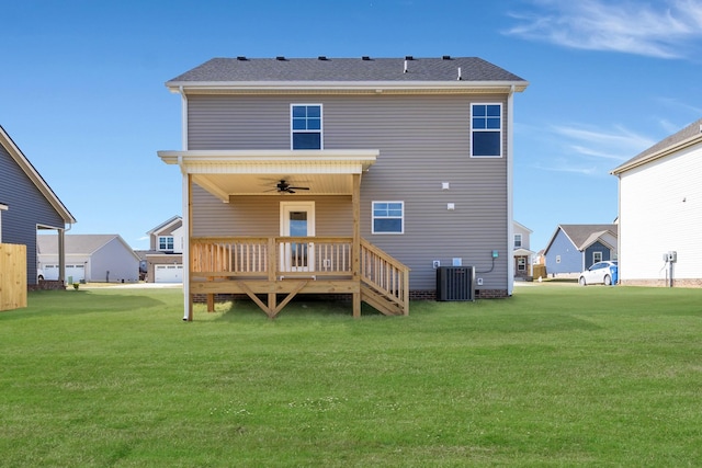 back of house with ceiling fan, a yard, a wooden deck, and central air condition unit