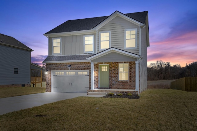 traditional-style home with a garage, driveway, brick siding, and a front lawn