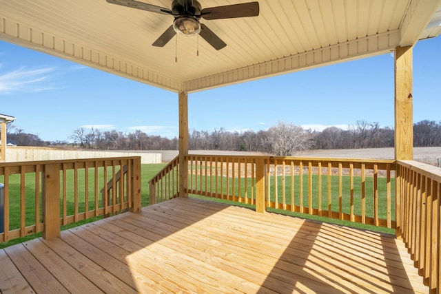 deck featuring ceiling fan and a lawn