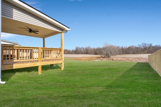 view of yard featuring a ceiling fan and a wooden deck