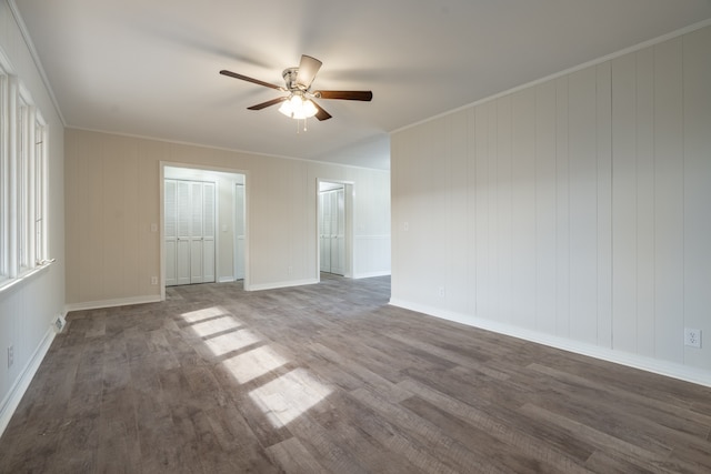 empty room featuring ornamental molding, wood-type flooring, and ceiling fan