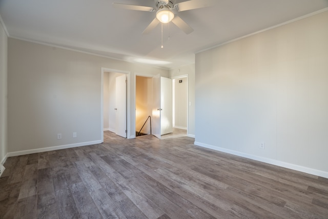 spare room with crown molding, ceiling fan, and wood-type flooring