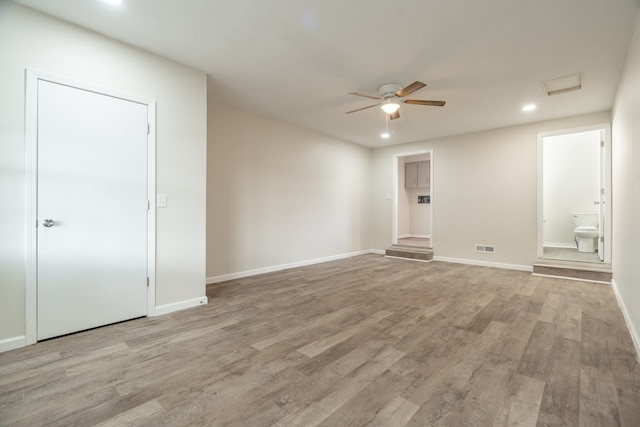 empty room with light hardwood / wood-style flooring and ceiling fan