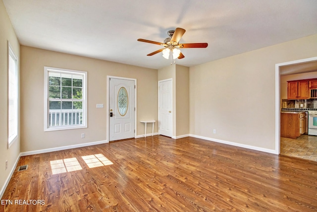 interior space with wood-type flooring and ceiling fan