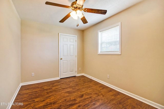 unfurnished room featuring ceiling fan and dark wood-type flooring