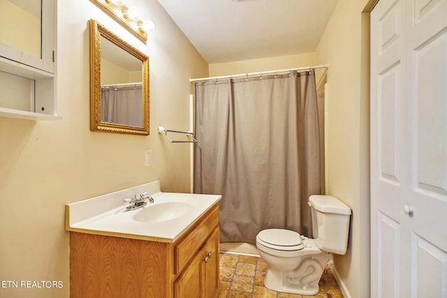 bathroom with walk in shower, vanity, and toilet