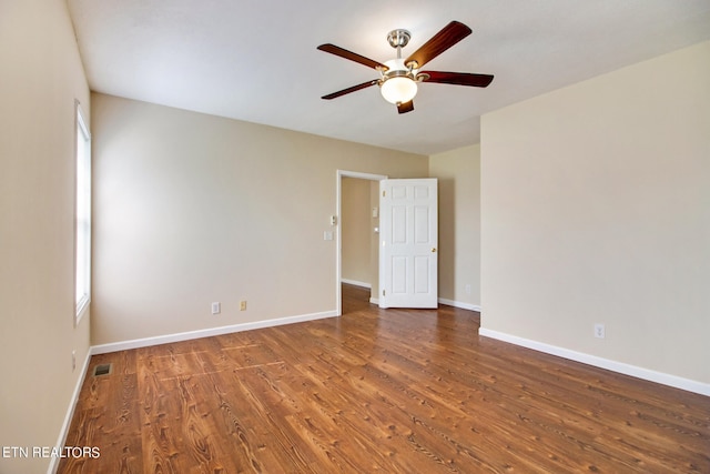 empty room featuring ceiling fan and dark hardwood / wood-style floors