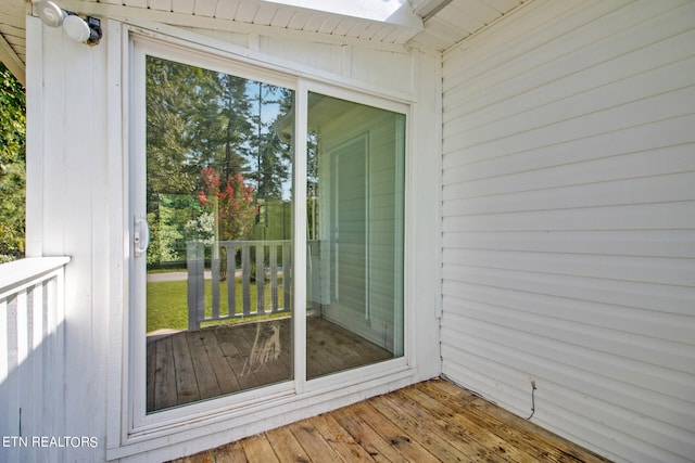 exterior space with wood ceiling, wood-type flooring, plenty of natural light, and wooden walls