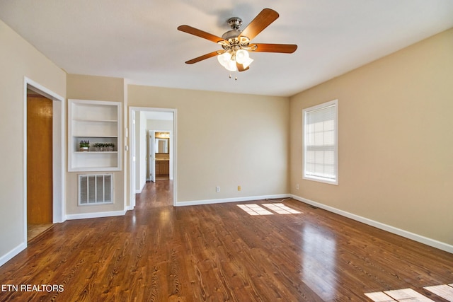 unfurnished living room featuring ceiling fan, dark wood-type flooring, and built in features