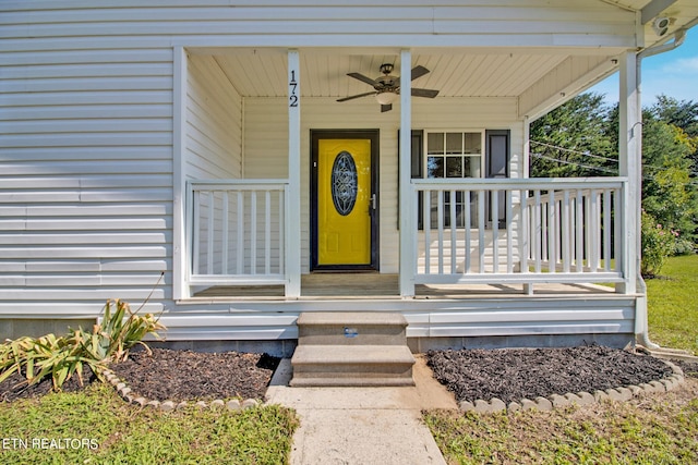 view of exterior entry with ceiling fan and covered porch