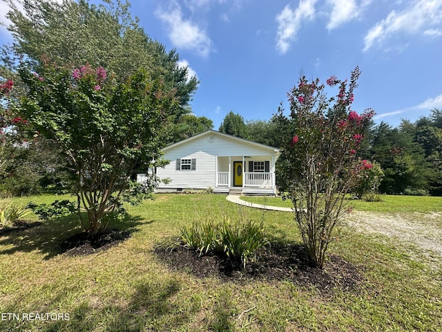 view of front of home with covered porch and a front yard