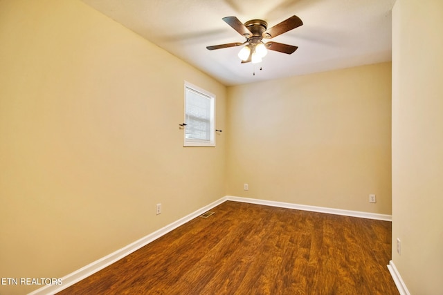 unfurnished room with ceiling fan and dark wood-type flooring