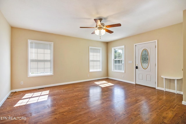 entrance foyer with ceiling fan, dark hardwood / wood-style floors, and a wealth of natural light