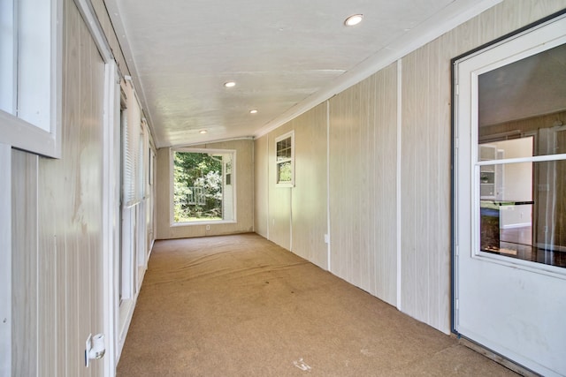 corridor with light carpet and lofted ceiling