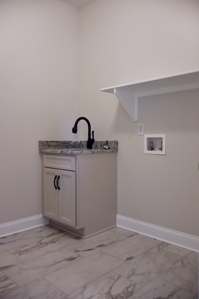 laundry area with hookup for a washing machine and sink