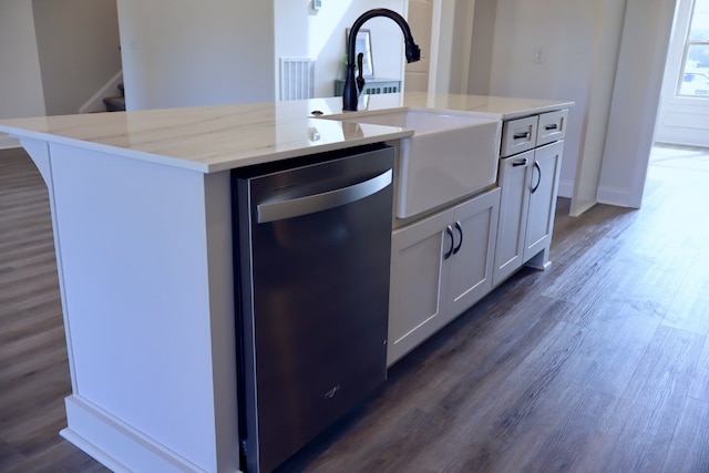 kitchen with a kitchen island with sink, dark hardwood / wood-style floors, white cabinetry, and stainless steel dishwasher